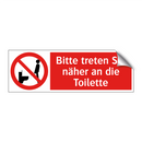 Bitte treten Sie näher an die Toilette