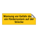 Warnung vor Gefahr durch ein Fördersystem auf der Strecke