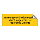 Warnung vor Einklemmgefahr durch ungeschützte rotierende Objekte