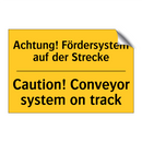 Achtung! Fördersystem auf der /.../ - Caution! Conveyor system on track/.../
