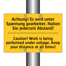 Achtung! Es wird unter Spannung /.../ - Caution! Work is being performed /.../