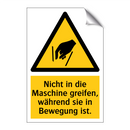 Nicht in die Maschine greifen, während sie in Bewegung ist.