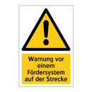 Warnung vor einem Fördersystem auf der Strecke