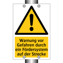 Warnung vor Gefahren durch ein Fördersystem auf der Strecke